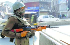 A security personnel stands guard in Srinagar on the eve of PM Narendra Modi’s visit to the Valley, on Wednesday
