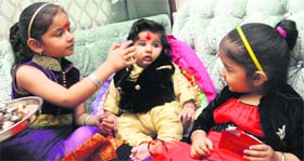 Bonds of love: A girl applies tilak on her brother’s forehead on the occasion of Bhai Dooj at Sector 20, Chandigarh, on Saturday