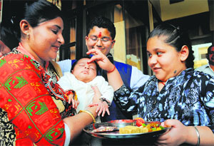 A girl applies tilak on the forehead of her brother on the occasion of Bhai Dooj in Ludhiana on Saturday.