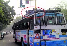 Students (encircled) of Government Model High School, Sector 43, seen travelling on the rooftop of a bus near the Sector 36/37 light point on Tuesday