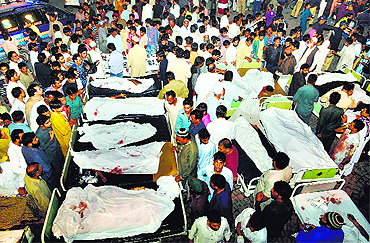 Relatives gather around the bodies of blast victims after a suicide bomb attack near the Wagah border on Sunday