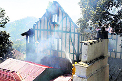 Fire fighters try to extinguish the fire at Minto Court (housing BROs Deepak Project) in Shimla on Sunday