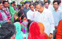 Chhattisgarh CM Raman Singh meets relatives of the victims in Bilaspur on Tuesday. PTI