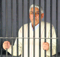 Rampal inside the lock-up at the Sector 5 police station in Panchkula on Thursday.