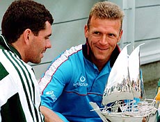 South African captain Hansie Cronje (left) and England captain Alex Stewart on Tuesday view the trophy for the Triangular Cricket Tournament between South Africa, England and Sri Lanka to be played next week at Headingley, Leeds. — AP/PTI