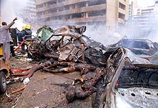 Burnt bodies lie beside damaged cars outside the American Embassy in Nairobi on Friday. A Huge explosion ripped apart a building in downtown Nairobi, heavily damaging the adjacent American Embassy and killing dozens.  AP/PTI