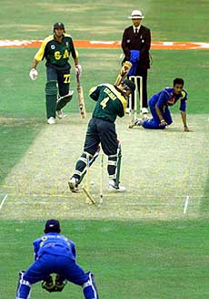 South Africa's Daryll Cullinan is bowled by Sri Lanka's Suresh Perera during the first match of the Emirates Triangular Tournament at Trent Bridge, Nottingham, on Friday. This is the first time that a one-day international has been played in England with teams wearing coloured clothing. — AP/PTI