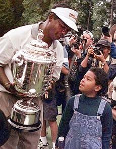 Vijay Singh shows off the Wanamaker Trophy to his son, Qass, after he won the 80th PGA Championship at the Sahalee Country Club in Redmond, Washington, on Sunday. AP/PTI