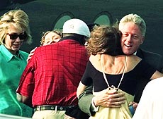 President Bill Clinton hugs singer Carly Simon, as his daughter Chelsea hugs family friend Vernon Jordan while first lady Hillary Clinton walks off Air Force One shortly after arriving at the Martha's Vineyard airport in West Tisbury on Tuesday. AP/PTI