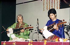 Noted sarod maestro Ustad Amjad Ali Khan with his younger son Ayaan Ali Bangash performing sarod recital at World Trade Centre in Singapore on August 18. — PTI