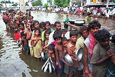 Hundreds of flood victims queue for relief handouts at the flooded port city of Narayangonj, south of capital Dhaka on Wednesday. The devastating flood has already claimed 580 lives and affected more than 20 million people.