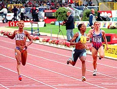 BRUSSELS, BELGIUM : Marion Jones of the U.S. (center) crosses the finish line to win the 100 meters ahead of Christine Arron of France (left) in the Memorial van Damme track and field meeting at the Brussels on Friday. At right is Irina Privalova of Russia.