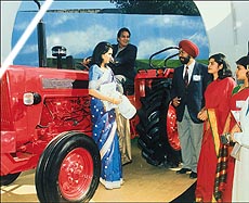 Actor Vinod Khanna tries his hand at a tractor at Agro-Tech in Chandigarh on Wednesday. — A Tribune photograph