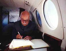 Union Home Minister L.K. Advani going through the files in an IAF aircraft on his way to Barmir Sector of Rajasthan on Monday to meet the jawans on the occasion of Armed Forces' Flag Day. — PTI