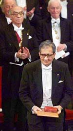 Professor Amartya Sen bows to the applause after receiving the Nobel Prize.