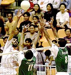 India's Amir Singh (15) goes up for a shot against Pakistan's Ali Zulfizar (11) and Nawaz Irfan (8) during their match at the 13th Asian Games in Bangkok on Saturday. India defeated Pakistan 15-4, 15-7, and 15-11 to win the match. AP/PTI