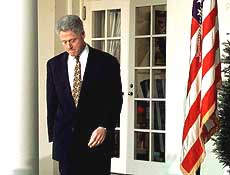 President Clinton walks into the Rose Garden.