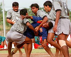 BANGKOK : Don Prasad Nilantha Weerasinghe of Sri Lanka (center) is tackled by Indian players in their Kabaddi match in the 13th Asian Games in Bangkok Tuesday. India won with score 76-13 and clinched the gold. AP/PTI