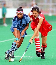 BANGKOK : Japan's Asuka Chiba (13) battles India's Manjinder Kaur for the ball during women's field hockey at the 13th Asian Games in Bangkok on Wednesday. Japan and India played to a 1-1 draw. AP/PTI