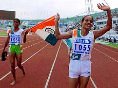 India's Jyotirmoyee Sikdhar (right) and teammate K. Rosakutty take a victory lap following victory — AP/PTI