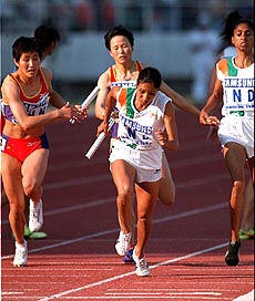 BANGKOK : Last runners, China's Chen Yuxiang (left) and India's Jyotimoyee Sikdar (center) receive a baton from third runners, Li Yulian of China (center background) and K. Rosa Kutty of India, during the Asian Games women's 4x400 meter relay final in Bangkok on Saturday. China won the race in 3:32.03 while India finished second, 3:32.20. AP/PTI
