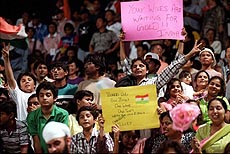 BANGKOK : Holding placards, Indian fans flash victory signs to celebrate their team's shootout victory over South Korean in the Asian Games men's field hockey final in Bangkok on Saturday. — AP/PTI