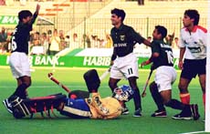 Pakistani players (from left) Atif Bashir, M. Anis, and Babar Abdullah celebrate second goal during their Champions Trophy field hockey tournament at the National Stadium in Lahore on Sunday. The match ended in 2-2 draw. AP/PTI