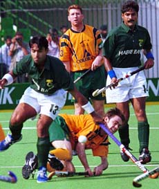 Australian forward Lachlan Vivian-Taylor, on ground, hits the ball at National Stadium in Lahore. The match between Pakistan and Australia ended in a draw (4-4) in the 20th Champions Trophy tournament. — AP/PTI