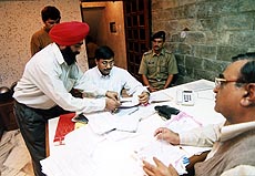 Sleuths of the Income Tax department carry out a survey of vegetable and fruit wholesalers at the vegetable market in Chandigarh on Friday