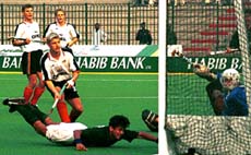 Haider Hussain of Pakistan pushes ball into the goal