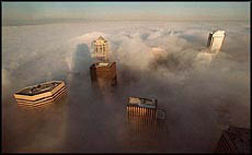 The Seattle skyline in USA looms above thick fog as seen from the top of the Columbia Tower Recently. 