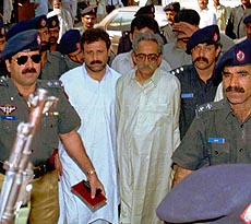 KARACHI : Shoaib Bokhari (second from left) and Wakil Jamali (third from left) are led into a Karachi courthouse for their trial on Tuesday. Police arrested the two Mutaheda da Qami Movement (MQM) lawmakers in Sindh province assembly on charge of terrorisim. AP/PTI