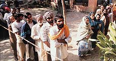 Voters waiting patiently to exercise their franchise in front of a polling booth in Adampur.