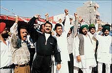 Congress workers shouting slogans against Punjab government, in Adampur, on Wednesday. 