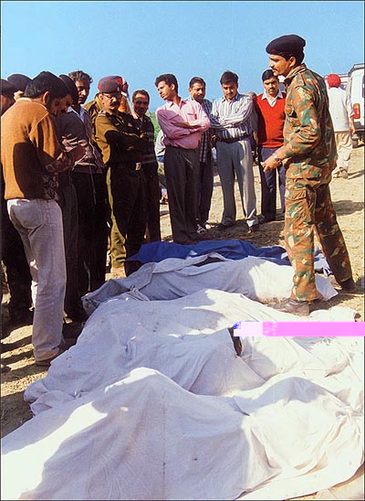 Officials near some of the bodies of the passengers of the ill-fated train