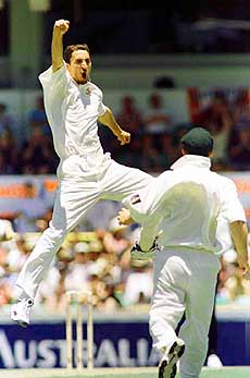 Australian bowler Jason Gillespie jumps in the air as he celebrates the wicket of England's John Crawly during the second ashes Test at the WACA cricket ground in Perth, Australia on Saturday