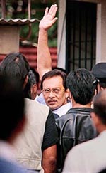 Jailed Malaysian reform leader Anwar Ibrahim, with blackened left eye, waves to supporters as he makes an appearance at court in Petaling Jaya, a suburb of Kuala Lumpur on Wednesday.
