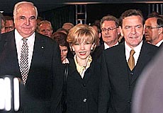 HANOVER : German chancellor Helmut Kohl (left) designated chancellor Gerhard Schroeder (right) and his wife Doris Schroeder-Koepf, meet on their way to an act of state in Hanover's congress center on Saturday, on the occasion of the ninth anniversary of the German unification. AP/PTI