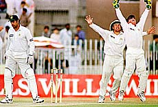 RAWALPINDI : Australian wicketkeeper Ian Healy (right) and captain Mark Taylor (second from right) celebrate the dismissal of Pakistani batsman Wasim Akram (left) at Pindi stadium in Rawalpindi on Sunday. Healy broke Rodney Marsh's world record of 355 victims when he had Akram caught behind on the fourth day of first Test between Pakistan and Australia. AP/PTI