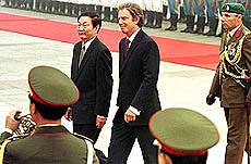 British Prime Minister Tony Blair (right) and Chinese Prime Minister Zhu Rongji review honor guards at the Great Hall of People, in front of Tiananmen Square in Beijing