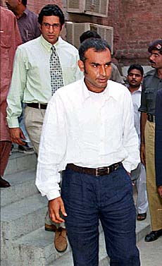Pakistani cricket team captain Amir Sohail and former captain Wasim Akram arrive to appear in the Lahore High Court on Thursday.
