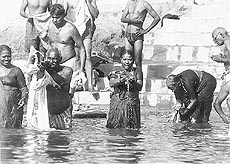 Devotees offering water to the Sun God after a dip in the Ganga. Photo by the writer