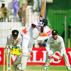 Pakistan opener Saeed Anwar drives Australia leg-spinner Stuart MacGill for four.