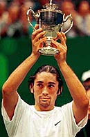 Chilean Marcelo Rios holds up the winning trophy of the Singapore Heineken Open Tennis Tournament