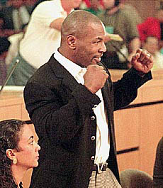 Mike Tyson strikes a boxing pose during his licensing hearing in front of the Nevada State Athletic Commission.