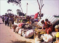 People living in low-lying areas along the Yamuna in Delhi are evacuated.
