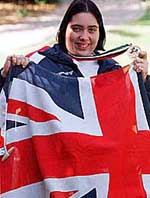 Emma Brown, 19, shows off her country flag and the gold medal she won, on the compound of British Embassy in Dubai on Wednesday. 