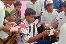 Saurav Gangauly, Indian batsman, signs autographs for fans at practice ground in Dhaka on Tursday. India will meet West Indies in the quarter-final of the Wills International one-day cricket tournament on Saturday. AP/PTI