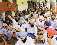 Employees of the Punjab Mandi Board staging a dharna in front of their head office in Sector 17, Chandigarh, on Thursday.