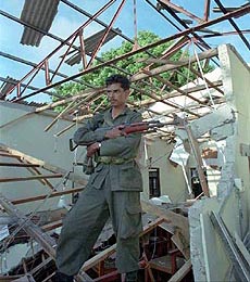 JAFFNA, SRI LANKA : A soldier stands guard shattered City Hall in Jaffna after a bomb explosion on Friday, which killed Mayor Ponnuthurai Sivapalan and 11 others.